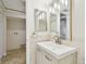 Bright bathroom features a modern vanity, elegant fixtures and includes a dedicated laundry area at 2650 Countryside Blvd # B-110, Clearwater, FL 33761