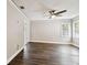Bedroom with hardwood floors and a ceiling fan, features sliding doors for natural light at 2650 Countryside Blvd # B-110, Clearwater, FL 33761