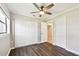 Charming bedroom featuring stylish dark wood floors, ample closet space, and a ceiling fan at 2650 Countryside Blvd # B-110, Clearwater, FL 33761