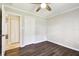 Bright bedroom features a ceiling fan, and dark wood-look flooring at 2650 Countryside Blvd # B-110, Clearwater, FL 33761