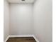 View of a small empty walk in closet with base trim and wood flooring at 2650 Countryside Blvd # B-110, Clearwater, FL 33761