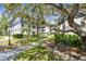 Beautiful condo exterior with a walkway, mature trees, and lush landscaping offering a tranquil setting at 2650 Countryside Blvd # B-110, Clearwater, FL 33761