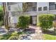Charming condo entrance with well-maintained landscaping, brick pathway and screened porch for outdoor enjoyment at 2650 Countryside Blvd # B-110, Clearwater, FL 33761