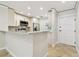 Well-lit kitchen area with stainless steel appliances and a breakfast bar that is ideal for casual dining at 2650 Countryside Blvd # B-110, Clearwater, FL 33761