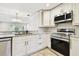Bright, updated kitchen with stainless steel appliances, modern cabinetry, and eat in bar at 2650 Countryside Blvd # B-110, Clearwater, FL 33761