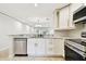 Updated kitchen featuring stainless steel appliances, white cabinetry and granite countertops at 2650 Countryside Blvd # B-110, Clearwater, FL 33761
