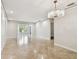 Bright and spacious living room featuring tile flooring and a contemporary chandelier and natural light at 2650 Countryside Blvd # B-110, Clearwater, FL 33761
