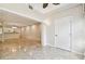 A light-filled living space flowing into an open kitchen with elegant tile flooring at 2650 Countryside Blvd # B-110, Clearwater, FL 33761
