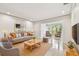 Staged living room with tile floors, cozy seating, and easy access to a sunny sitting room at 2650 Countryside Blvd # B-110, Clearwater, FL 33761