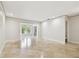 Bright living room with neutral walls, tile floors and large windows offering lots of natural light at 2650 Countryside Blvd # B-110, Clearwater, FL 33761