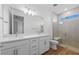 Modern bathroom showcasing a double vanity, sleek fixtures, and a glass-enclosed shower at 27153 Capri Shores Cir, Englewood, FL 34223