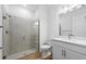 Stylish bathroom with a glass-enclosed shower, modern fixtures, and a neutral color palette at 27153 Capri Shores Cir, Englewood, FL 34223