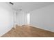 Bright bedroom featuring wood-look tile flooring and multiple doorways for flexible access at 27153 Capri Shores Cir, Englewood, FL 34223