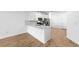Spacious kitchen with white cabinets, stainless steel appliances, and a large island at 27153 Capri Shores Cir, Englewood, FL 34223