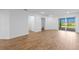 Open-concept living room featuring wood floors and sliding glass doors to the patio at 27153 Capri Shores Cir, Englewood, FL 34223