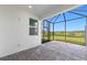 This screened patio features brick flooring, natural light, and provides scenic views of the lush green landscape at 27153 Capri Shores Cir, Englewood, FL 34223