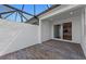 Outdoor patio with brick flooring and screened enclosure with sliding glass door access to home at 27153 Capri Shores Cir, Englewood, FL 34223