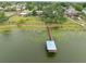 Aerial view of dock and lake showing a scenic waterfront retreat with a wooden dock extending into the serene lake waters at 2906 Beagle Pl, Seffner, FL 33584