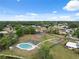 An aerial shot featuring neighborhood amenities including a pool, tennis courts, and playground area at 2906 Beagle Pl, Seffner, FL 33584