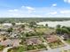 An aerial view showcasing the property within a lush residential neighborhood near a lake at 2906 Beagle Pl, Seffner, FL 33584