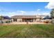 The spacious backyard features an extended brick patio with seating and shade perfect for entertaining at 2906 Beagle Pl, Seffner, FL 33584