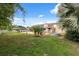 Spacious backyard with a concrete patio featuring outdoor furniture and a metal stock tank pool at 2906 Beagle Pl, Seffner, FL 33584