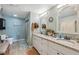 Bathroom featuring a double sink vanity with framed mirrors and a separate shower at 2906 Beagle Pl, Seffner, FL 33584