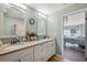 Bathroom featuring a double sink vanity with framed mirrors and plenty of storage at 2906 Beagle Pl, Seffner, FL 33584