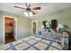 Bedroom with view to walk-in closet, dark laminate floors, and ceiling fan at 2906 Beagle Pl, Seffner, FL 33584