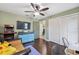 Spacious bedroom boasts a ceiling fan, TV, closet, and dark wood floors adding function to the living space at 2906 Beagle Pl, Seffner, FL 33584