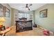 Charming bedroom features a ceiling fan, window seat, and tiled floors making it a comfortable sanctuary at 2906 Beagle Pl, Seffner, FL 33584