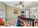 Warm and inviting bedroom features a ceiling fan, and sliding doors leading to the backyard at 2906 Beagle Pl, Seffner, FL 33584