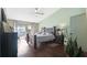Tranquil bedroom with natural light, wood floors, and access to outdoor patio area at 2906 Beagle Pl, Seffner, FL 33584