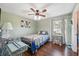 Bedroom with dark laminate floors, natural light, and ceiling fan at 2906 Beagle Pl, Seffner, FL 33584