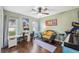 Cozy bedroom featuring a ceiling fan, wood floors, and natural light creating a comfortable and inviting space at 2906 Beagle Pl, Seffner, FL 33584
