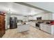 Well-lit kitchen with a center island, granite countertops, stainless steel appliances, and tile floors at 2906 Beagle Pl, Seffner, FL 33584