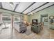 Inviting living area boasting natural light, a beamed ceiling, neutral decor, and tile flooring at 2906 Beagle Pl, Seffner, FL 33584