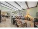Open living area featuring beamed ceilings, neutral tones, tile flooring, and ample seating at 2906 Beagle Pl, Seffner, FL 33584