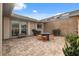 Charming outdoor patio area featuring brick pavers, comfortable seating, and lush greenery for a relaxing ambiance at 2906 Beagle Pl, Seffner, FL 33584