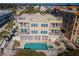 Aerial view of building with balconies, pool, spa, and ocean view, and community at 3 7Th Ave # 3, Indian Rocks Beach, FL 33785