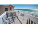 Balcony with a metal bench overlooking the beach and ocean at 3 7Th Ave # 3, Indian Rocks Beach, FL 33785
