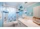Bathroom with updated marble vanity, shower/tub combination with blue accents at 3 7Th Ave # 3, Indian Rocks Beach, FL 33785