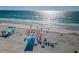 Aerial view of a sunny beach with people sunbathing and swimming in the ocean at 3 7Th Ave # 3, Indian Rocks Beach, FL 33785