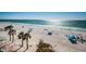 Beautiful beach view with clear water, palm trees, and people enjoying the sunny day at 3 7Th Ave # 3, Indian Rocks Beach, FL 33785