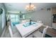 Open-concept dining area boasts beautiful water views, modern lighting, and a stylish white dining table at 3 7Th Ave # 3, Indian Rocks Beach, FL 33785