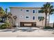 Beach condo with covered parking, palm trees, and neutral exterior with white trim at 3 7Th Ave # 3, Indian Rocks Beach, FL 33785