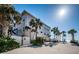 Coastal condo featuring covered parking, beach access, and lush tropical landscaping at 3 7Th Ave # 3, Indian Rocks Beach, FL 33785