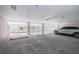 View of ground level parking garage with vehicle, pool access, and gated fence at 3 7Th Ave # 3, Indian Rocks Beach, FL 33785
