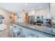 Bright kitchen featuring granite countertops, stainless steel appliances, and bar stool seating at 3 7Th Ave # 3, Indian Rocks Beach, FL 33785