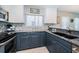 Modern kitchen with updated appliances, backsplash, and granite countertops at 3 7Th Ave # 3, Indian Rocks Beach, FL 33785